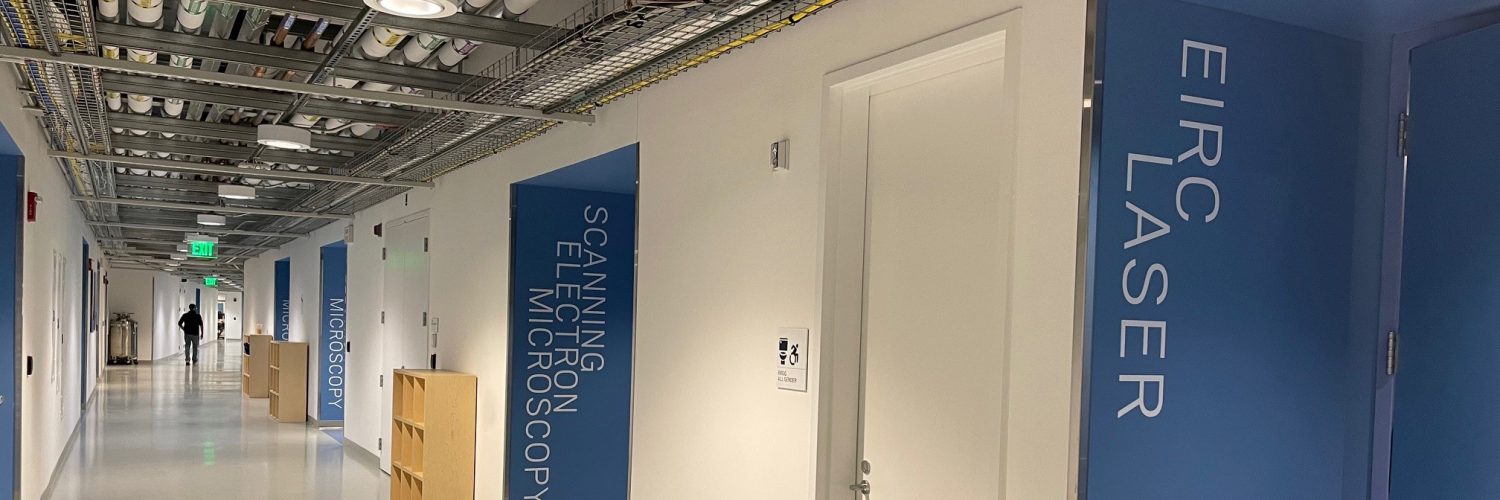 Image of UConn IMS core labs hallway with lab names on wall outside lab